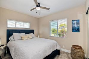 a bedroom with a bed and a ceiling fan at Ocean View Spa Retreat, Hot Tub, Sauna, Close to the beach, 9 sleeps in Oceanside +29 photos