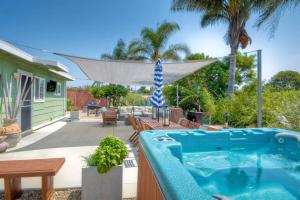 a backyard with a swimming pool and a house at Ocean View Spa Retreat, Hot Tub, Sauna, Close to the beach, 9 sleeps in Oceanside