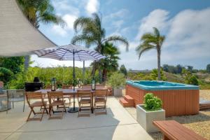 a patio with a table and chairs and a swimming pool at Ocean View Spa Retreat, Hot Tub, Sauna, Close to the beach, 9 sleeps in Oceanside