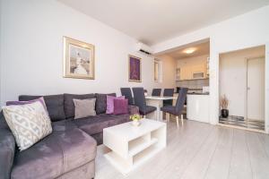 a living room with a couch and a table at Isaura Apartments in Dubrovnik