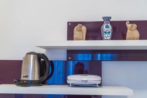 a shelf with a coffee pot and vases on it at Isaura Apartments in Dubrovnik
