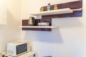a microwave oven sitting on top of a shelf at Isaura Apartments in Dubrovnik +8 photos