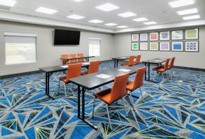 a conference room with tables and chairs and a screen at Holiday Inn Express Hillsboro I-35 by IHG in Hillsboro +61 photos