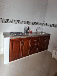 a kitchen with a sink and a counter top at Hotel la casona de Wiky in Guaduas