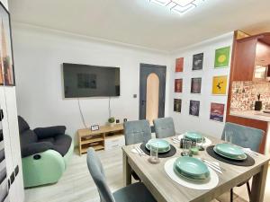 a dining room with a table and chairs and a television at Best Family Apartment in Varna City