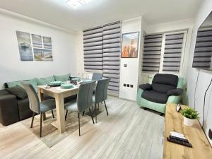 a living room with a dining room table and chairs at Best Family Apartment in Varna City
