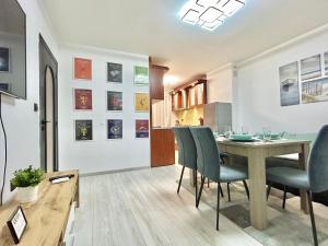 a dining room and kitchen with a table and chairs at Best Family Apartment in Varna City