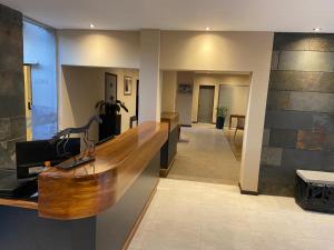 a lobby with a wooden counter in a building at Tierra Mora in San Rafael