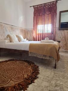 a bedroom with a large bed and a rug at La Flor De La Xara in Alájar