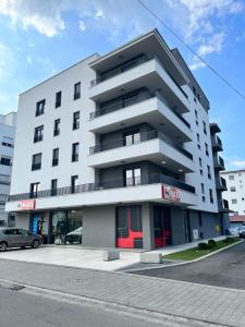 a large white building with a car parked in front of it at LadyDi apartman in Banja Koviljača