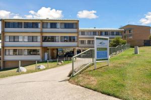 a building with a sign in front of it at Alpine Mountain View 39 Ground Floor 3 Bedroom Unit in Jindabyne