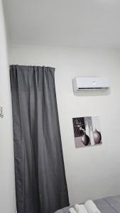 a bathroom with a black shower curtain and a picture at HOTEL CRISARI in Naples