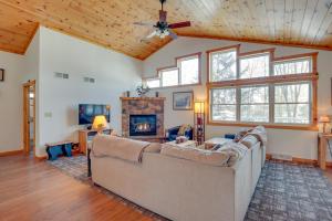 a living room with a couch and a fireplace at Lakefront Tomahawk Getaway with Deck and 2 Fireplaces! in Tomahawk