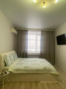 Ένα ή περισσότερα κρεβάτια σε δωμάτιο στο Комфортабельные - Уютные квартиры в Костанай (Береке)