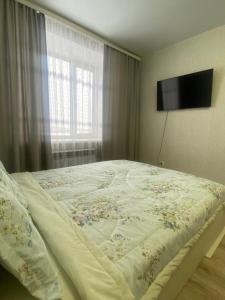 Ένα ή περισσότερα κρεβάτια σε δωμάτιο στο Комфортабельные - Уютные квартиры в Костанай (Береке)