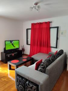 a living room with a couch and a tv at Delfina`s House in Machico +12 photos