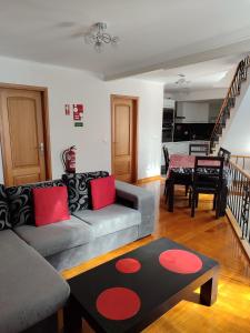 a living room with a couch and a table at Delfina`s House in Machico
