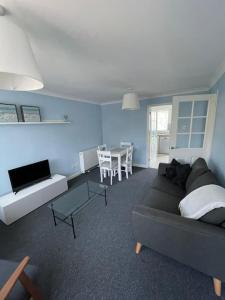 a living room with a couch and a table at Peaceful centrally located, 2 Bedroom Bungalow. in Camborne
