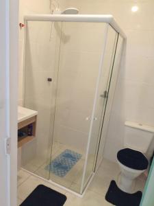 a bathroom with a glass shower with a toilet at Casa da Dinda in Penha
