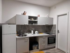 a small kitchen with a sink and a refrigerator at Apartment Grey Deluxe in Sarajevo