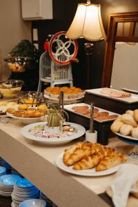 a table topped with plates of food and pastries at Auckland City Hotel - Hobson St in Auckland