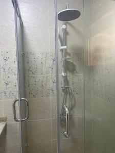 a shower with a glass door in a bathroom at Monte cairo Pool View in Cairo
