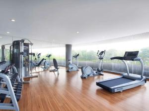a gym with a bunch of exercise equipment in a room at Ibis Styles Jakarta Airport in Tangerang
