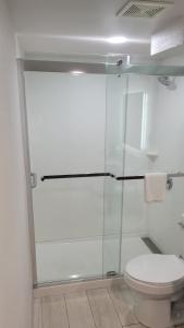 a bathroom with a glass shower with a toilet at Quality Inn Forsyth near GA Public Safety Training Center in Forsyth