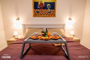 a table with two plates of food on a bed at Villa Stefina in Kotor +28 photos