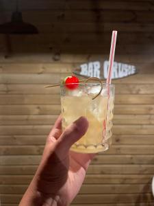 a hand holding a drink with a cherry on it at Casa Tinti in Tintipan Island
