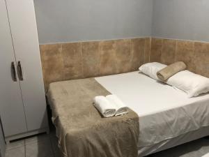 Postel nebo postele na pokoji v ubytování Cantinho da Neide