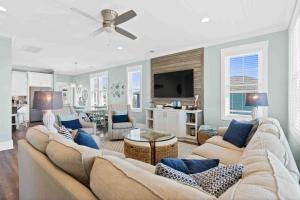 a living room with a couch and a table at Beers and Sunshine Ocean Isle Beach, Heated pool, elevator, across from beach access in Ocean Isle Beach