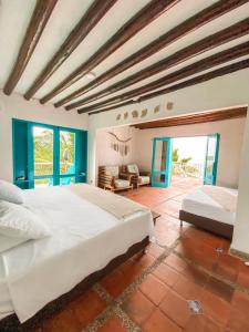 a large bedroom with two beds in a room at Casa Tinti Hotel Boutique in Tintipan Island