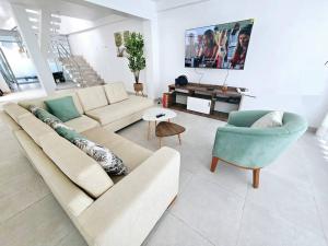 a living room with a couch and a chair at Casa de Playa Luxury Laguna Azul Tacna in Tacna