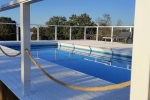 a swimming pool with a yellow rope around it at Trullo Iris in Cisternino