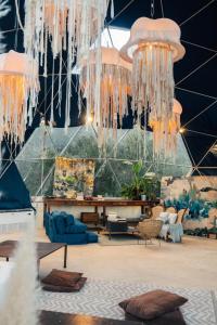 a large room with chandeliers and furniture in it at Big Bang Nature Stays in Sauce de Portezuelo