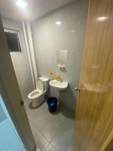 a small bathroom with a toilet and a sink at CANA Homestay Petaling Jaya in Petaling Jaya