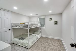 a bedroom with two bunk beds in a room at Lower-Level Apartment in District Heights Near DC! in District Heights