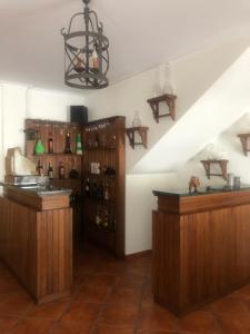 a wine tasting room with wooden cabinets and a staircase at Paradise Valley House in São Martinho do Porto