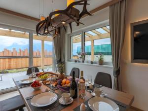 a dining room with a table with fruits and wine bottles at Kitzbüheler Alpenlodge Top A3 in Mittersill