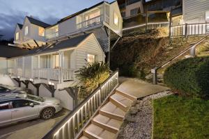 a house with a car parked in front of it at Lakeview Colonial House in Queenstown