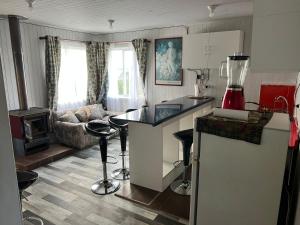 a kitchen and living room with a couch and a counter at Arenas de Ancud in Ancud