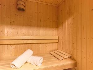 a wooden sauna with two towels on a shelf at Kitzbüheler Alpenlodge Top A2 in Mittersill