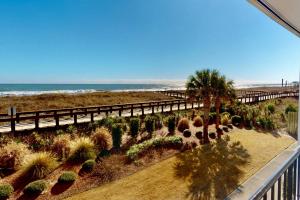 a balcony with a view of the beach and the ocean at Casa Al Mare in Carolina Beach +42 photos