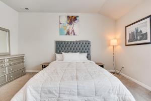 a white bedroom with a bed and a dresser at Union City Townhome 17 Mi to Downtown Atlanta! in Union City