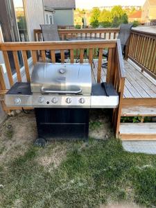 a barbecue grill sitting on a deck on a porch at Cheerful 3 bd home with easy access to interstate! in Omaha
