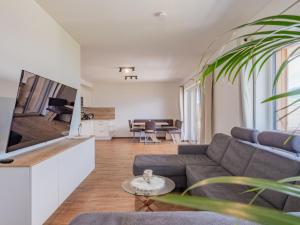a living room with a couch and a table at Hoferlitzlhubgut in Mittersill