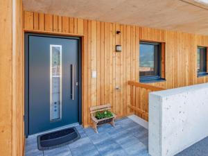 a house with a blue door and a bench at Hoferlitzlhubgut in Mittersill