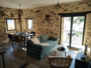a living room with a couch and a table at U MULINU in Moïta