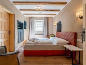 um quarto com uma cama, uma mesa e uma janela em Biber Art Chalet em Biberwier